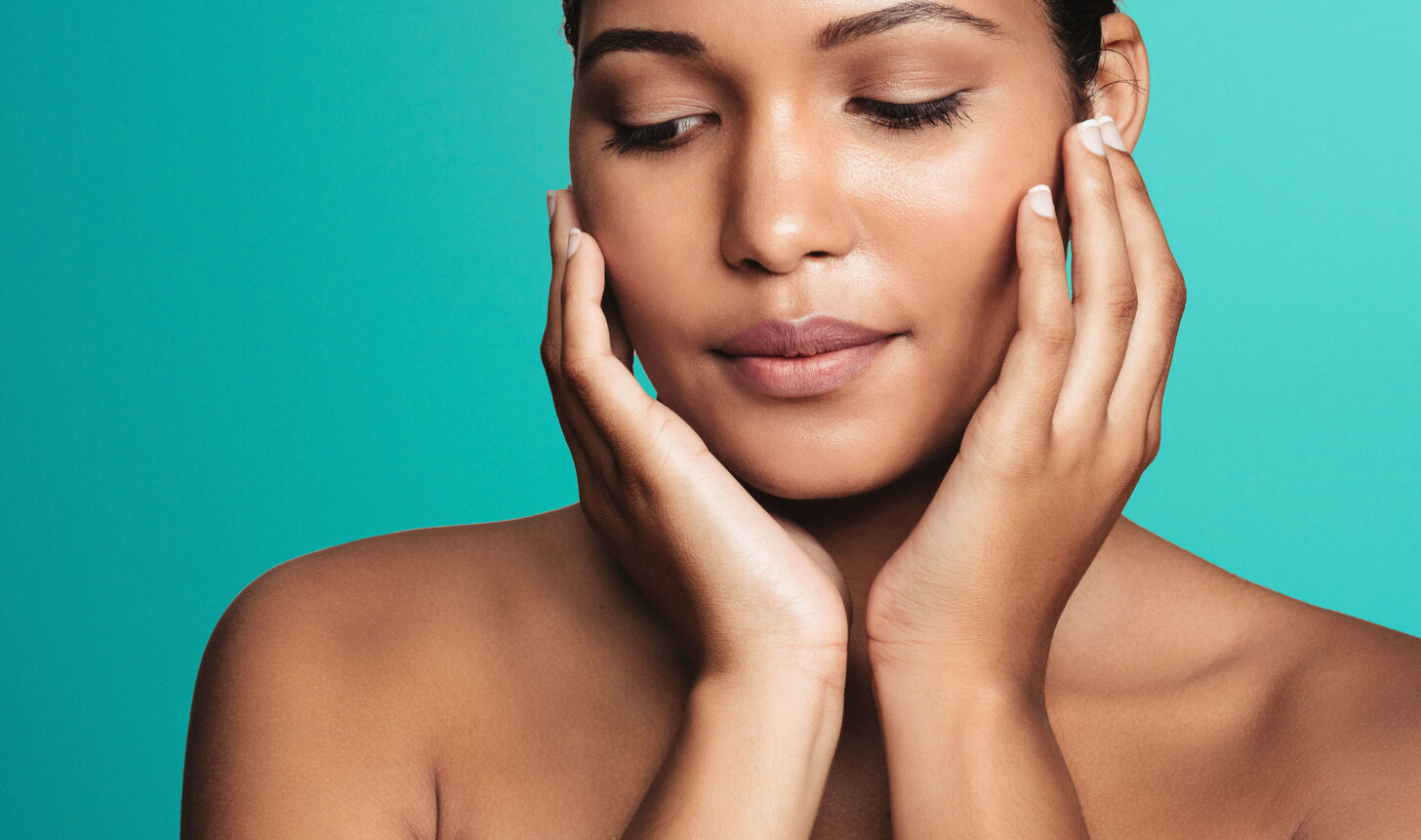 Close-up of a woman with eyes closed framing her face with both hands against for Morpheus8 skin remodelling in Amsterdam