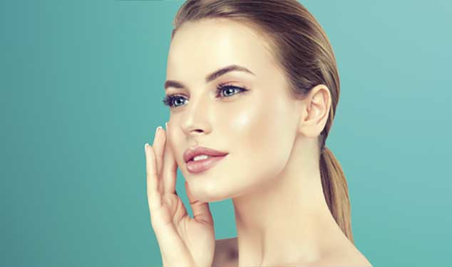 Woman in profile touching her cheek with one hand against a teal background for Morpheus8 skin remodelling in Amsterdam